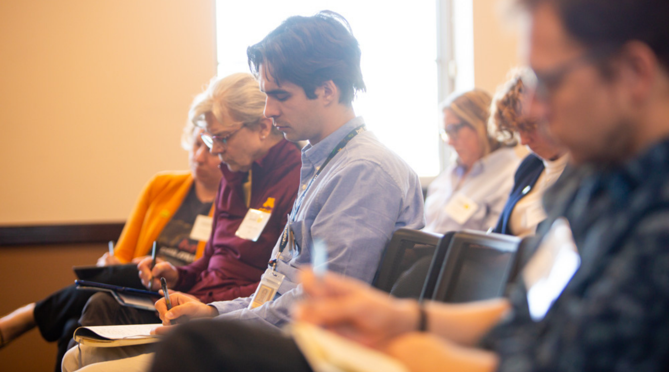 Speaking Science attendees take notes during a conference breakout session.